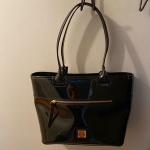 Dooney & Bourke patent zip tote. Black shinny leather with front zipper.